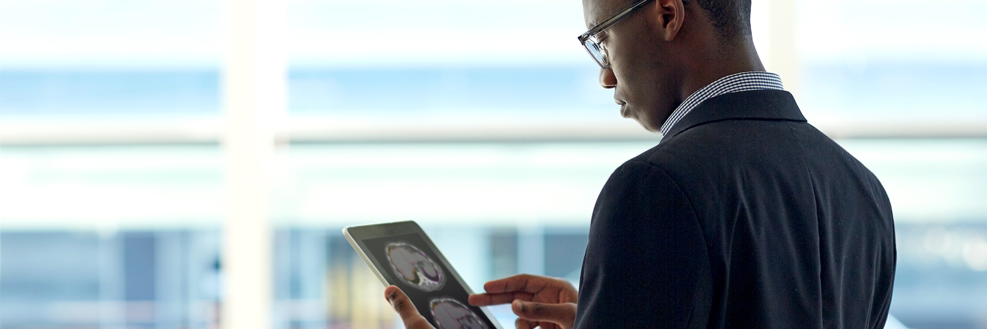 Radiologist in the atrium of a modern-looking convention center